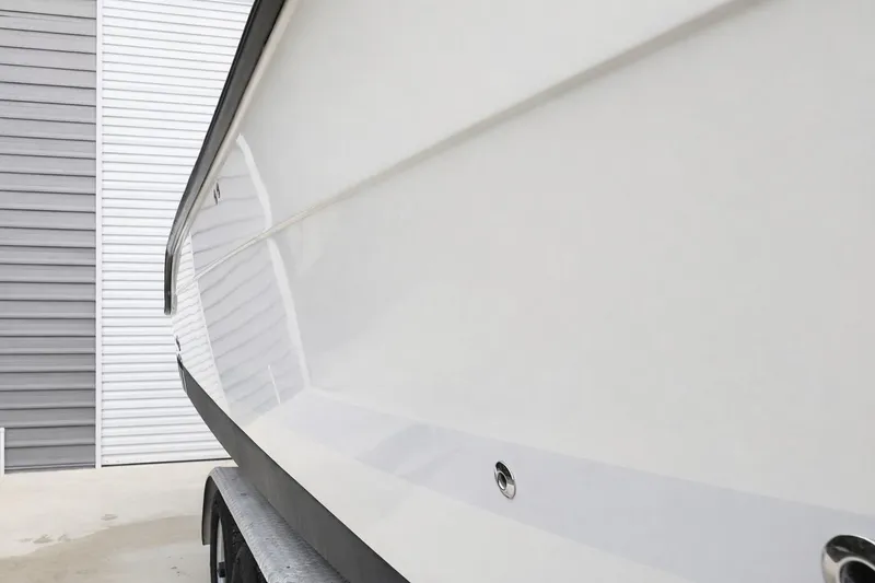 Slide: The Image of 2008 Hydra-Sports Vector 2900 CC boat hull, parked near a gray and white building. - 32