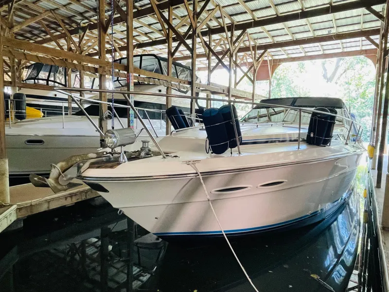 Slide: The Image of 1989 Sea Ray 390 Express Cruiser in covered boathouse. - 11