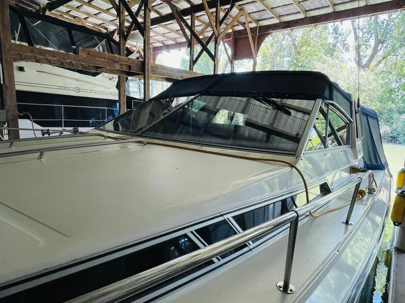 Slide: The Image of 1989 Sea Ray 390 Express Cruiser in covered dock. - 12