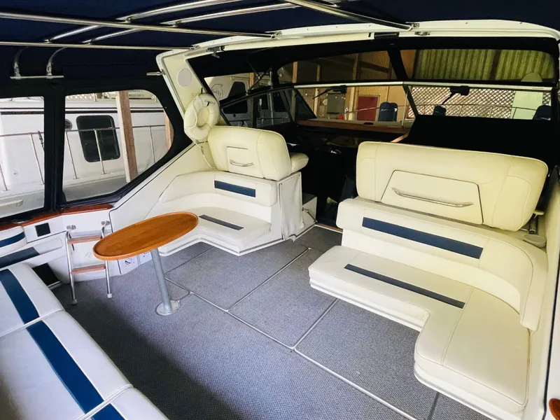 Slide: The Image of Interior of 1989 Sea Ray 390 Express Cruiser with white leather seating. - 13