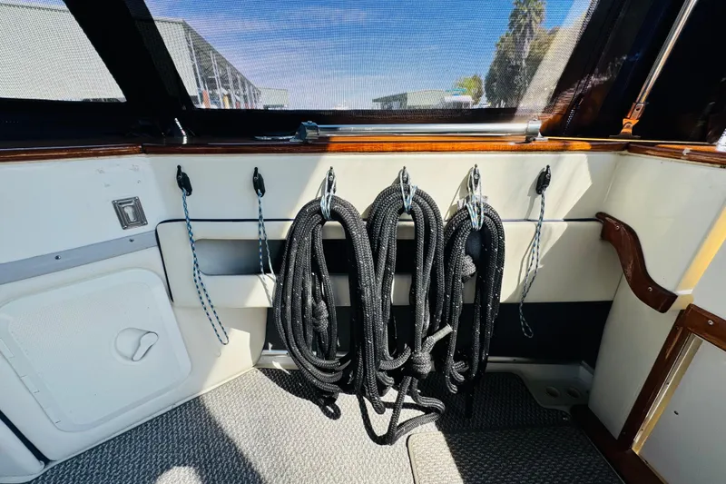 Slide: The Image of 1989 Sea Ray 390 Express Cruiser interior with coiled ropes and wood accents. - 17