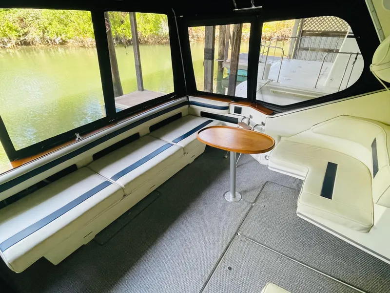 Slide: The Image of Interior of a 1989 Sea Ray 390 Express Cruiser with seating area. - 20