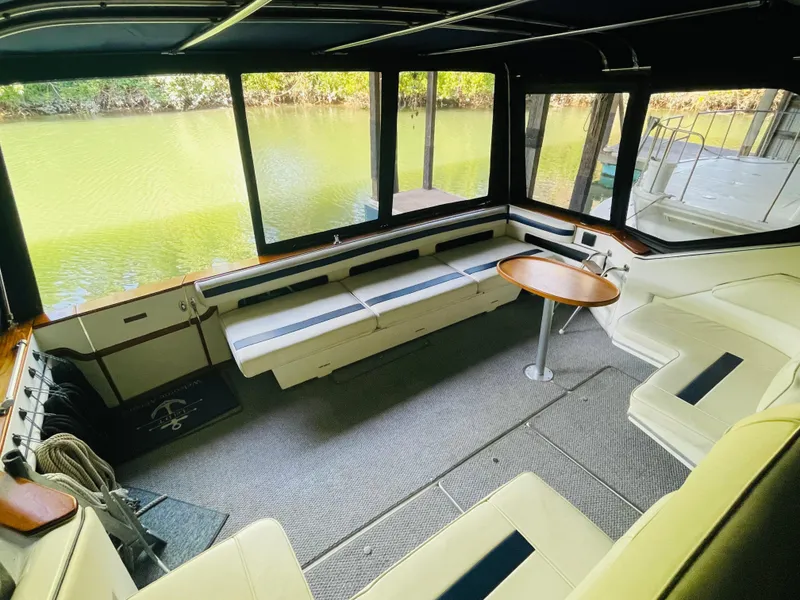 Slide: The Image of Interior of 1989 Sea Ray 390 Express Cruiser with seating area and table. - 21