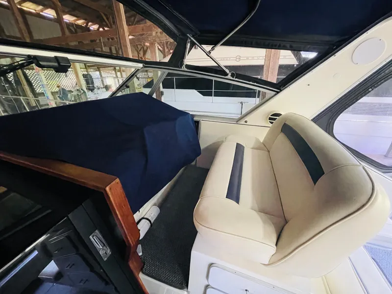 Slide: The Image of Interior of a 1989 Sea Ray 390 Express Cruiser with beige seating. - 25