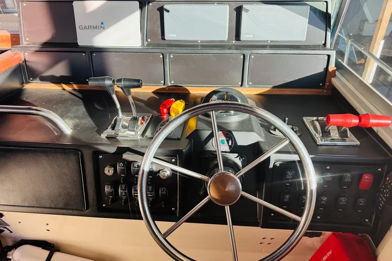 Slide: The Image of 1989 Sea Ray 390 Express Cruiser helm with Garmin navigation and control panel. - 28