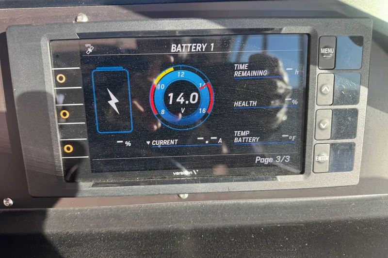Slide: The Image of Battery monitor display on 1989 Sea Ray 390 Express Cruiser showing voltage and status. - 38