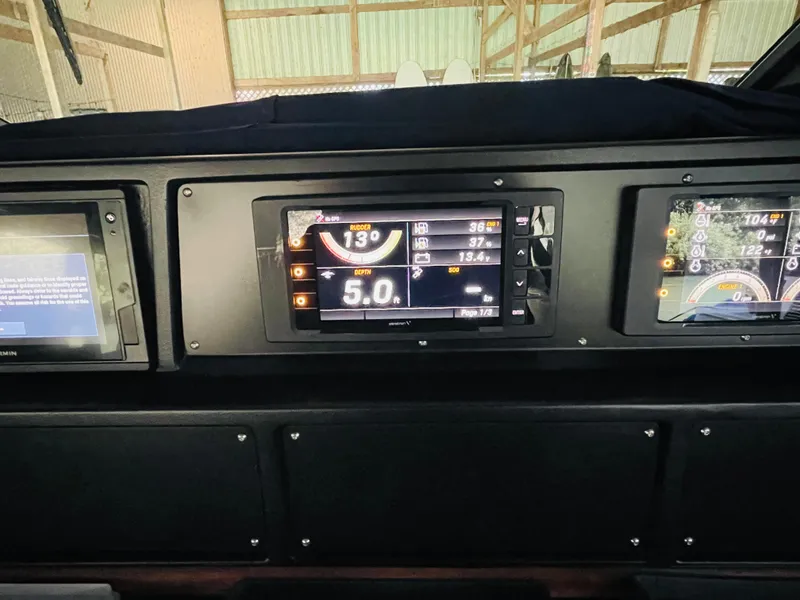 Slide: The Image of Dashboard of a 1989 Sea Ray 390 Express Cruiser with digital displays. - 39