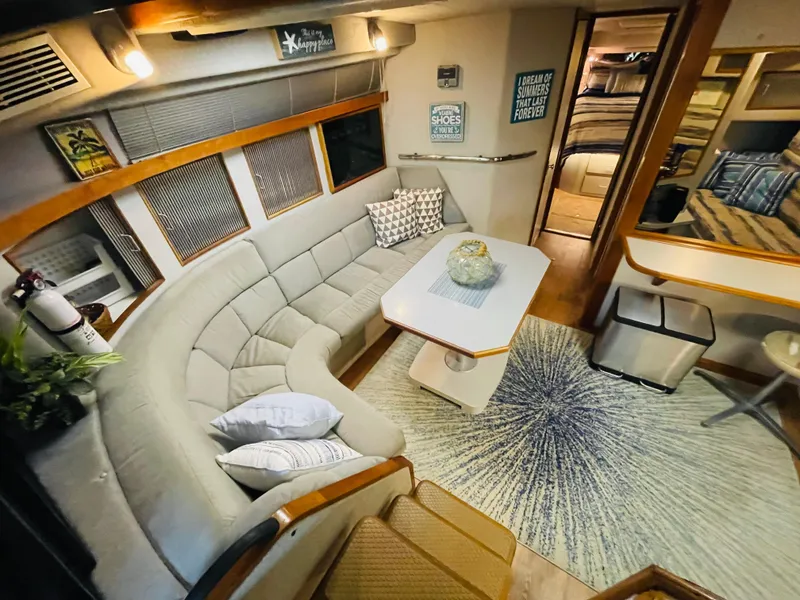 Slide: The Image of 1989 Sea Ray 390 Express Cruiser interior with cozy seating and table. - 43