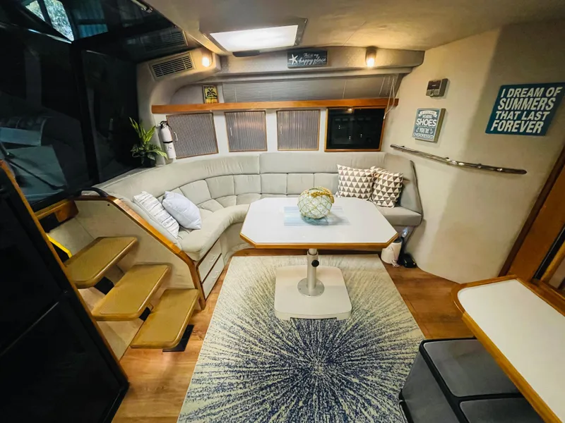 Slide: The Image of Interior of a 1989 Sea Ray 390 Express Cruiser with cozy seating area. - 45