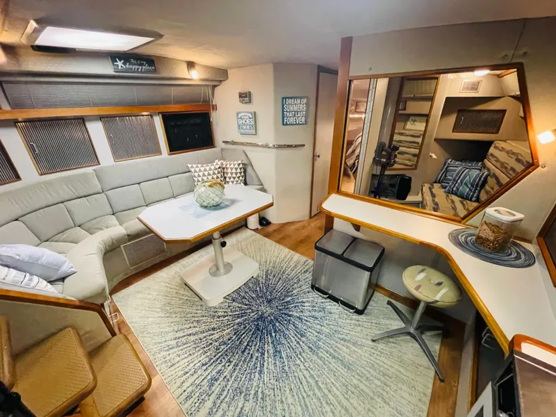 Slide: The Image of Interior of a 1989 Sea Ray 390 Express Cruiser with cozy seating area. - 47
