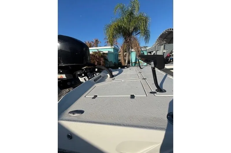 Slide: The Image of 2007 Talon F21 boat deck with motor, palm trees, and clear blue sky. - 10