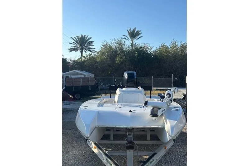 Slide: The Image of 2007 Talon F21 boat on trailer, parked outdoors with palm trees in background. - 2