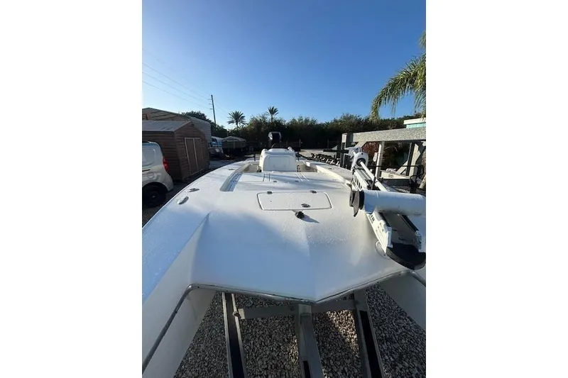 Slide: The Image of 2007 Talon F21 boat on trailer, parked outdoors under clear blue sky. - 3