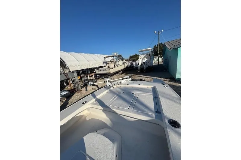 Slide: The Image of 2007 Talon F21 boat in storage yard under clear blue sky. - 6