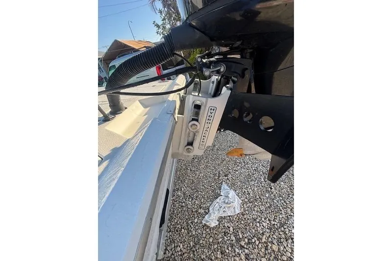 Slide: The Image of Boat motor with Hydro Jacker on 2007 Talon F21, parked on gravel. - 7