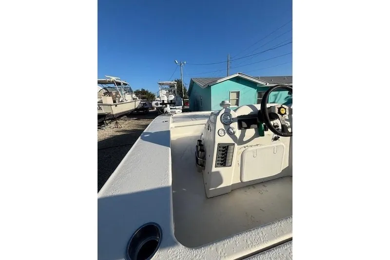 Slide: The Image of 2007 Talon F21 boat interior with steering wheel and control panel under clear blue sky. - 8