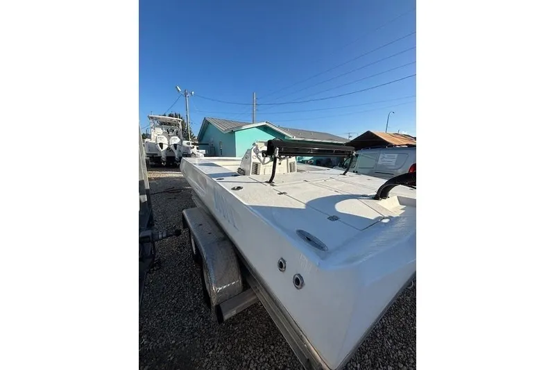 Slide: The Image of 2007 Talon F21 boat on trailer, parked outdoors under clear blue sky. - 9