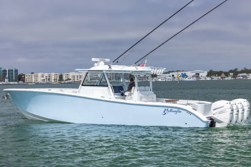 The Image of 2020 Yellowfin 42 Offshore boat cruising on water with cityscape background. - 0
