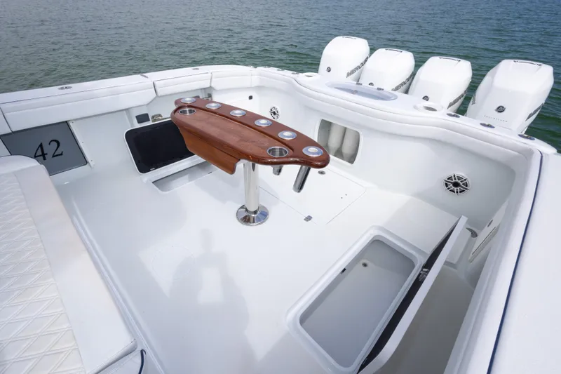 Slide: The Image of 2020 Yellowfin 42 Offshore boat deck with fishing rod holders and storage compartments. - 19