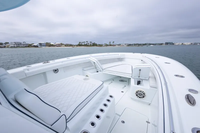 Slide: The Image of 2020 Yellowfin 42 Offshore boat interior with seating, on calm water. - 2