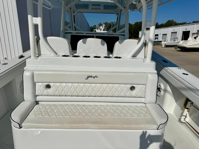 Slide: The Image of 2020 Yellowfin 42 Offshore cabin with wooden flooring, seating, and compact toilet. - 25