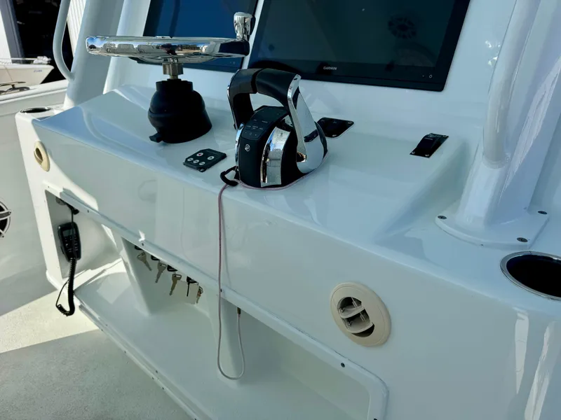 Slide: The Image of 2020 Yellowfin 42 Offshore boat on calm water with coastal buildings in background. - 29