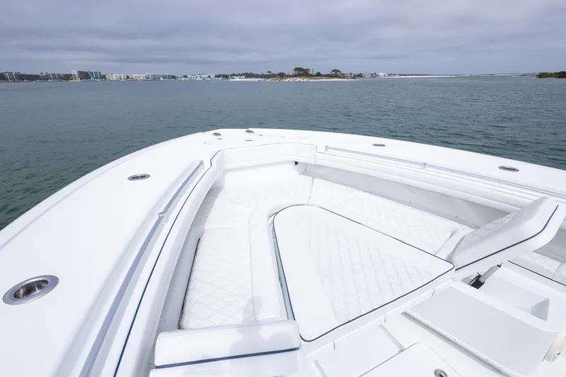 Slide: The Image of 2020 Yellowfin 42 Offshore boat with spacious white seating, overlooking calm waters. - 4