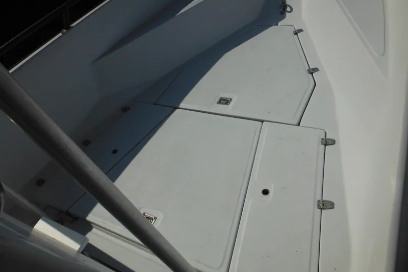 Slide: The Image of 1990 Boston Whaler Guardian 22 boat deck with storage compartments. - 10
