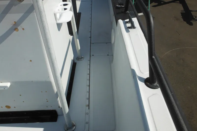 Slide: The Image of 1990 Boston Whaler Guardian 22 boat deck with railings and rod holders. - 13