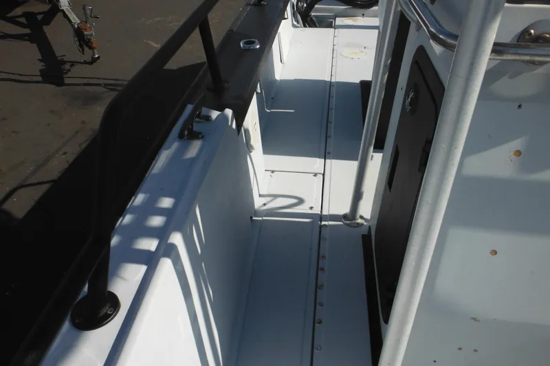 Slide: The Image of 1990 Boston Whaler Guardian 22 interior view, showcasing deck and railing details. - 14