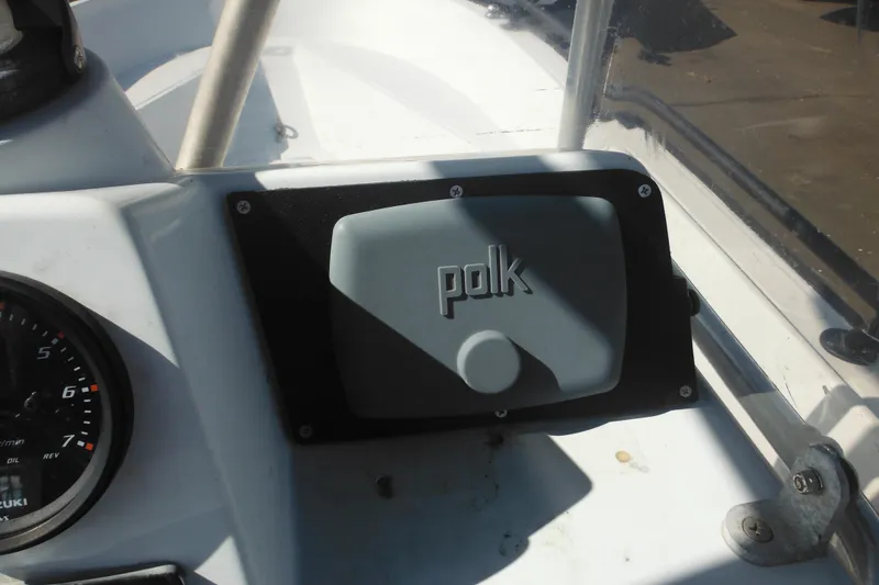 Slide: The Image of 1990 Boston Whaler Guardian 22 dashboard with Polk audio cover and Suzuki gauge. - 21