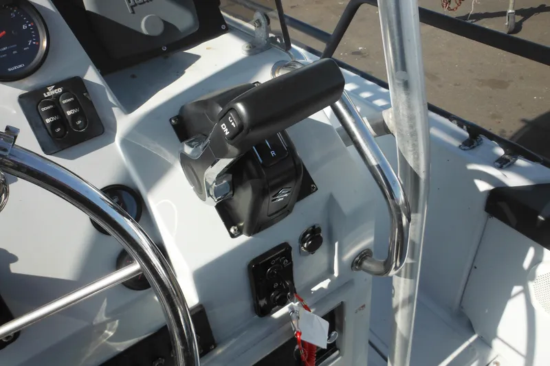 Slide: The Image of 1990 Boston Whaler Guardian 22 boat controls and steering wheel close-up. - 23