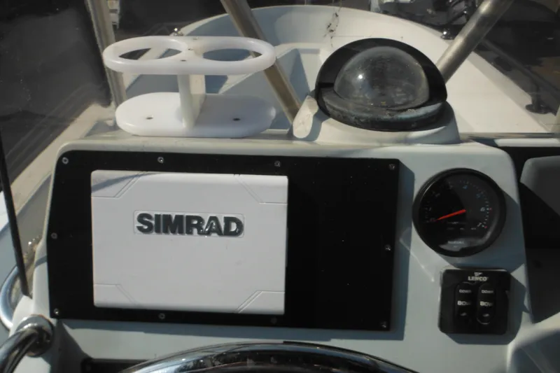 Slide: The Image of 1990 Boston Whaler Guardian 22 dashboard with Simrad navigation system and compass. - 24