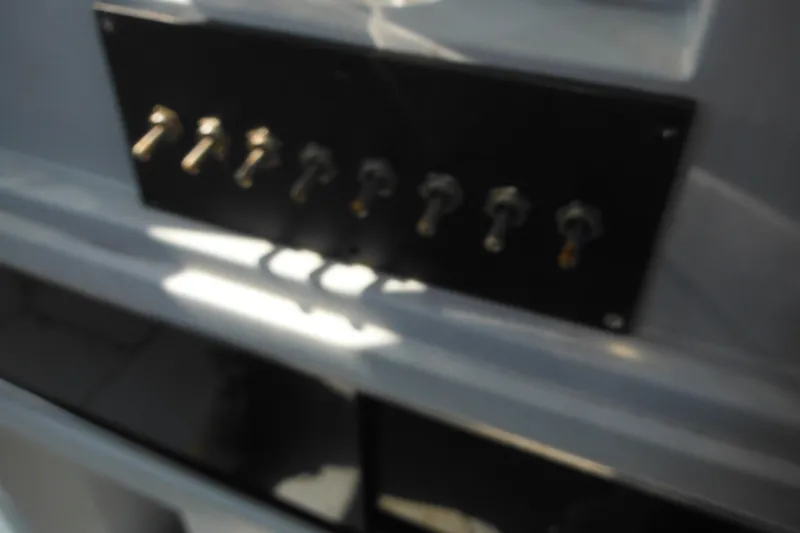 Slide: The Image of Control panel of a 1990 Boston Whaler Guardian 22 boat, featuring multiple switches. - 25