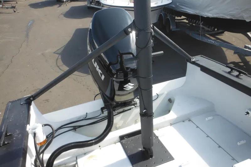 Slide: The Image of 1990 Boston Whaler Guardian 22 with Suzuki outboard motor, docked on a sunny day. - 29