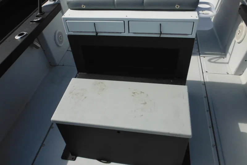 Slide: The Image of 1990 Boston Whaler Guardian 22 interior with storage compartments and seating. - 31