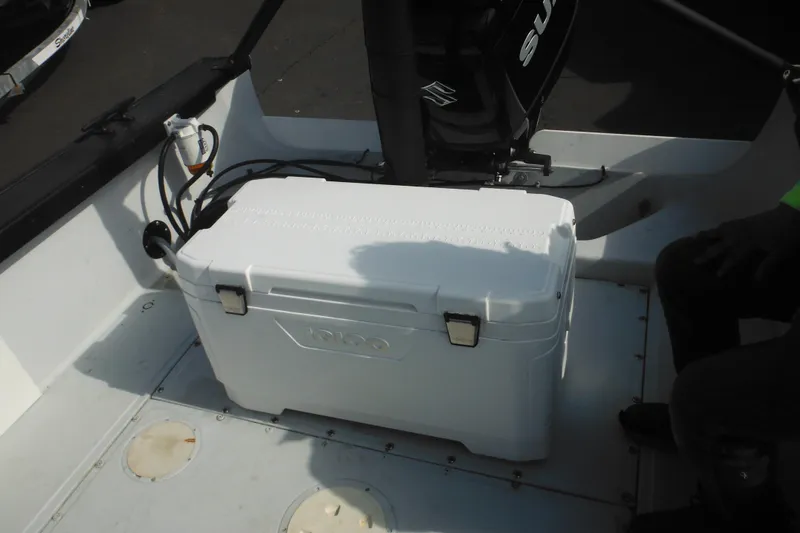 Slide: The Image of 1990 Boston Whaler Guardian 22 interior with cooler and Suzuki engine. - 34