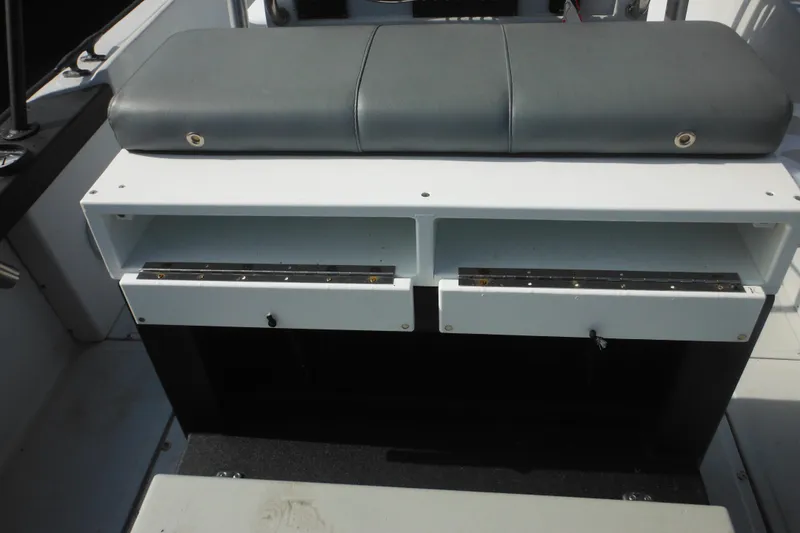 Slide: The Image of 1990 Boston Whaler Guardian 22 boat interior with cushioned seating and storage compartments. - 35