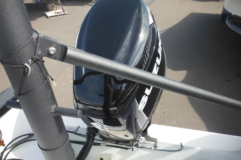 Slide: The Image of 1990 Boston Whaler Guardian 22 with Suzuki outboard motor, docked on a sunny day. - 36