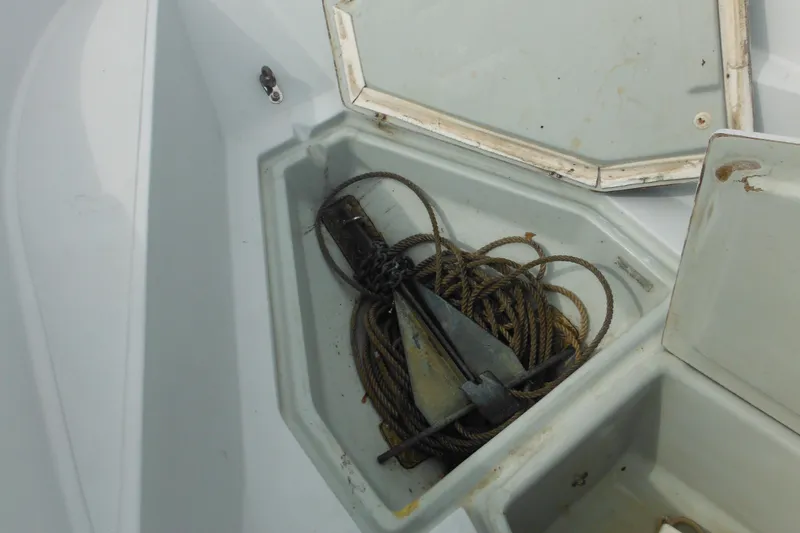 Slide: The Image of Open storage compartment on 1990 Boston Whaler Guardian 22 with anchor and rope. - 38