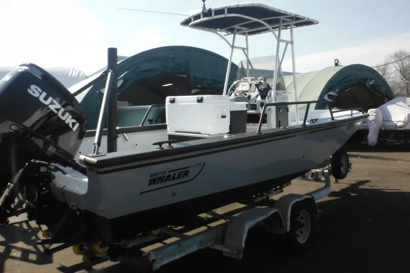 Slide: The Image of 1990 Boston Whaler Guardian 22 boat with Suzuki outboard motor on trailer. - 6