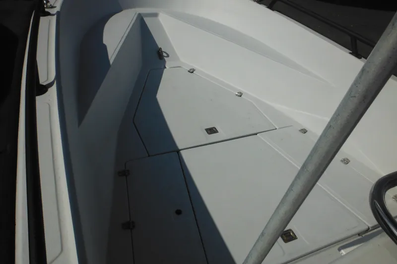 Slide: The Image of 1990 Boston Whaler Guardian 22 boat deck with storage compartments. - 9