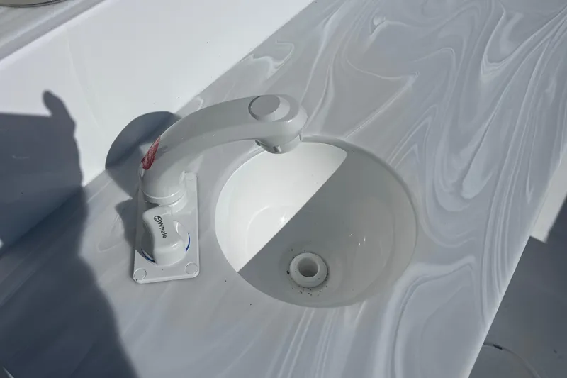 Slide: The Image of White sink and faucet on Sea Hunt Ultra 265 SE boat, 2025 model. - 11