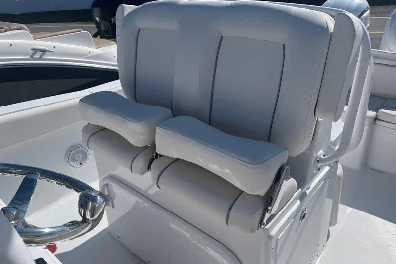 Slide: The Image of Luxury seating on 2025 Sea Hunt Ultra 265 SE boat, featuring plush white upholstery. - 12