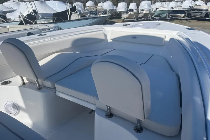 Slide: The Image of 2025 Sea Hunt Ultra 265 SE boat interior with cushioned seating and storage. - 17
