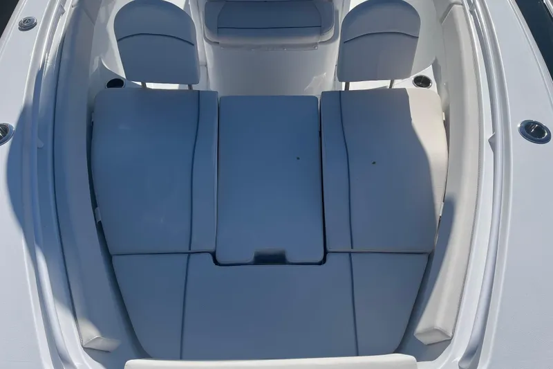Slide: The Image of 2025 Sea Hunt Ultra 265 SE boat interior with cushioned seating area. - 18