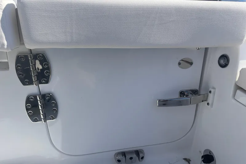 Slide: The Image of 2025 Sea Hunt Ultra 265 SE boat door with stainless steel hinges and latch. - 21