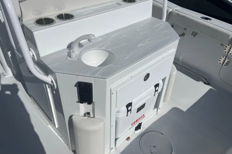 Slide: The Image of Interior of 2025 Sea Hunt Ultra 265 SE boat with sink and storage. - 7