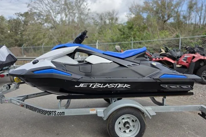 Slide: The Image of 2025 Yamaha WaveRunner JetBlaster on trailer, black and blue design, parked outdoors. - 2