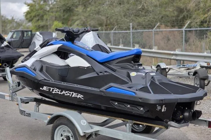 Slide: The Image of 2025 Yamaha WaveRunner JetBlaster on trailer, sleek black and blue design. - 4